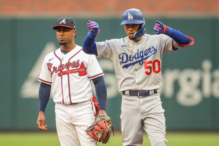 May 23, 2023; Cumberland, Georgia, USA; Los Angeles Dodgers second baseman Mookie Betts (50) reacts next to Atlanta Braves second baseman Ozzie Albies (1) after hitting a double during the first inning at Truist Park.